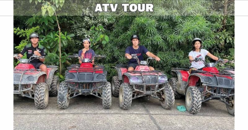 two riders sitting on ATV quad bikes parked side by side with trees in background