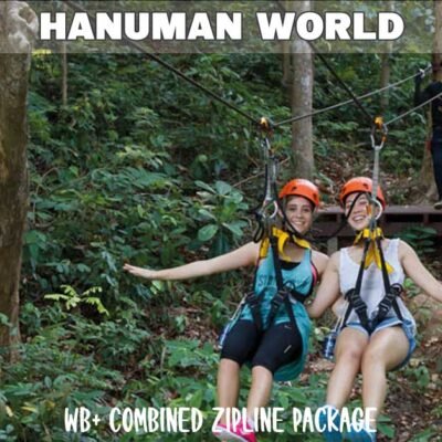 phuket zipline park with two females ziplining side by side wearing full safety gear and colorful clothes