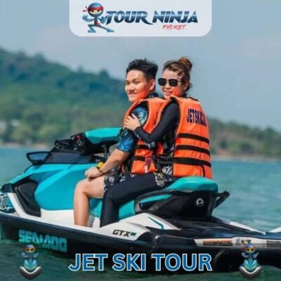 smiling asian couple wearing life jackets while riding powerful turquoise and black jet ski near shore in Phuket