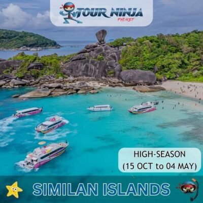 aerial view of typical idylic Similan island showing several boats and multiple tourists on the beach