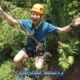adventure zipline fun in phuket with a participant wearing orange safety helmet gliding through the jungle