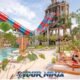 water park andamanda phuket with family of three enjoy drinks in the sun beds next to the waterslides and pool
