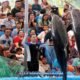 two large dolphins jumping out of the water simultaneously at the dolphin show in phuket in front of a large crowd