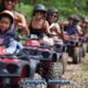 atv safari tour with a group of atv riders following each other on a trail through the jungle