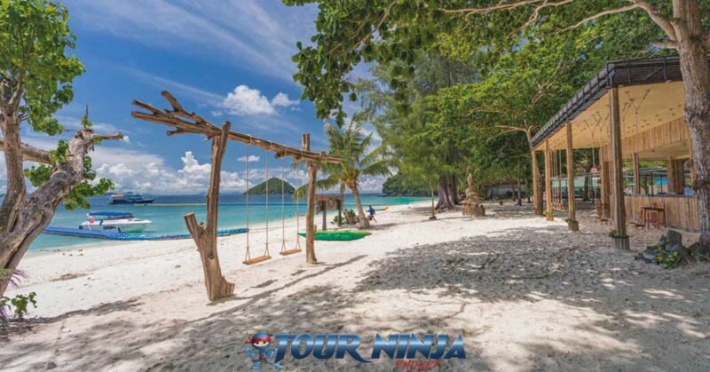 coral-island-daytrip-beach-n2 coral island beautiful white beach and turquoise sea showing wooden swings and restaurant with trees