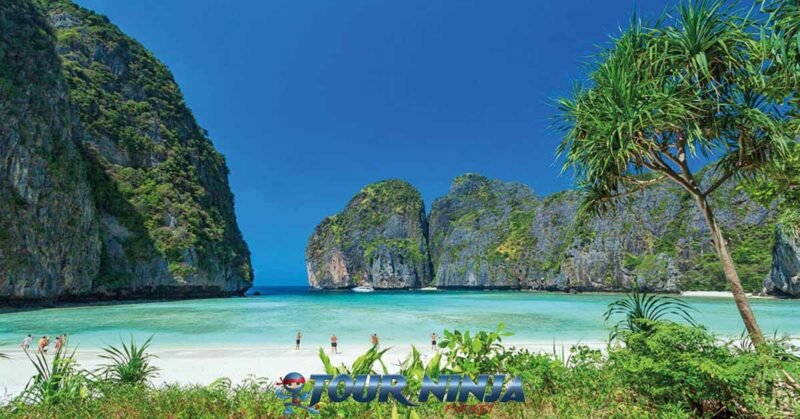 daytrip-phiphi-island-maya-bay-s8 maya bay phi phi island viewed from the beach with its beautiful white sand and turquoise sea and limestone rock formations