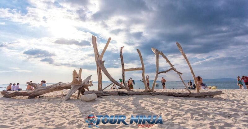 daytrip-phiphi-khai-island-s3 khai island name on large wooden sign on a white sandy beach