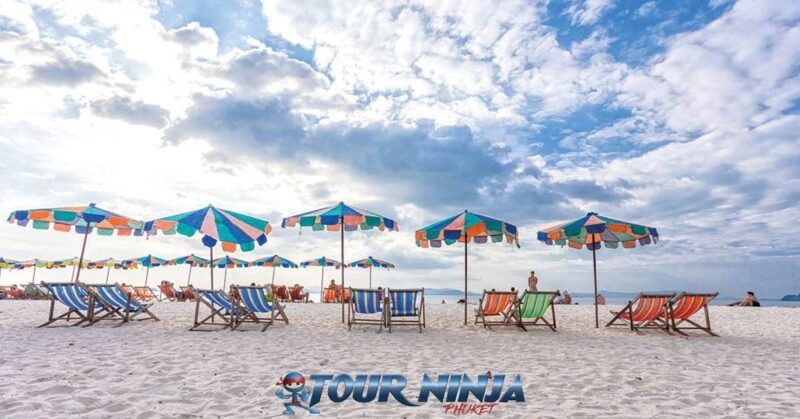 daytrip-phiphi-khai-island-s5 khai island white sandy beach with colorful beach chairs and beach umbrellas and bright sunny sky