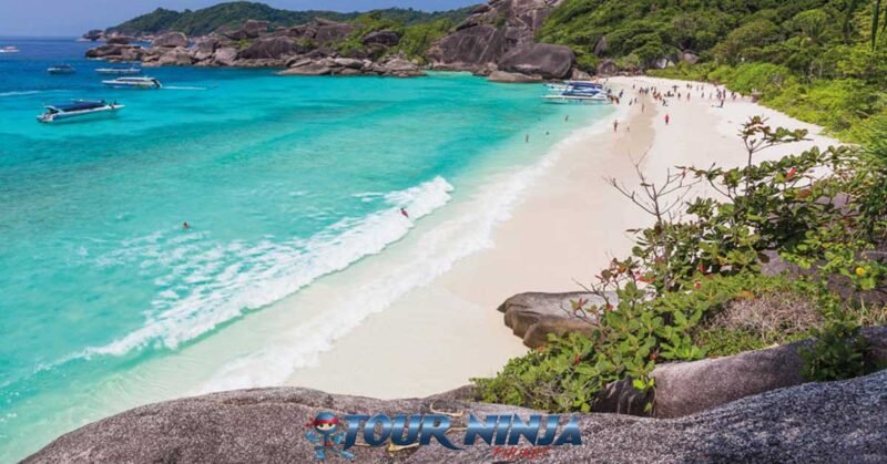 daytrip-snorkeling-similan-island-s4 similan island donald duck bay seen from a viewpoint with several speedboat off loading people onto the beautiful tropical beach