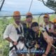 extreme zipline tour with a group of five asian males standing on a zipline platform ready to zipline