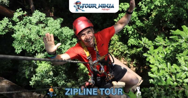 zipline-abseil-hw3 smiling man looks up and waves both hands while abseiling at zipline park in jungle