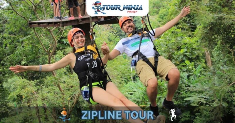 dual-zipline-phuket-jungle-hw1 smiling couple with outstretched arms hold hands while enjoying dual zipline jungle ride