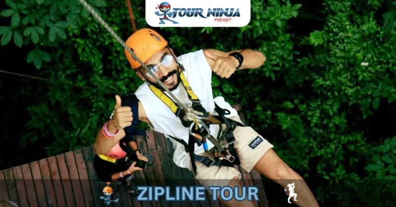 phuket-zipline-abseil-hw3 smiling male gives two thumbs up during zipline abseil amongst trees of Phuket jungle