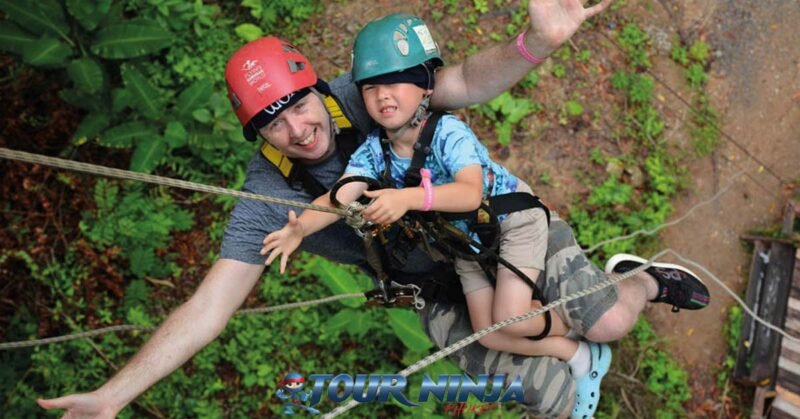 family-friendly-zipline-tours-phuket-hw4 father and son abseiling down from a zipline platform in the phuket zipline adventure park