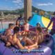 andamanda phuket water park with six young people sitting in a large inflatable tube ready to descend into the large slider