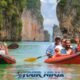 phang nga bay limestone rock formations viewed from two inflatable red kayaks with two tourist and a paddle guide in each