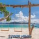 coral island wooden selfie swing on kahung beach with stunning tropical sea background