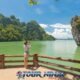 james bond island being photographed by female tourist in phang nga bay on a beautiful sunny day