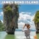 james bond island photographed by female tourist standing on a small beach in phang nga bay on a sunny day