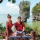 james bond island tour with a couple sitting at a small viewpoint with james bond island as a back drop