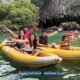 james bond island daytrip with happy tourist in two yellow sea canoes wavering to the camera