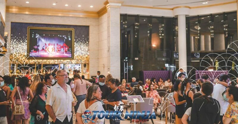 ladyboy-entertainment-show-phuket simon cabaret phuket with lots of tourist standing and sitting in the bar area enjoying drinks and snacks