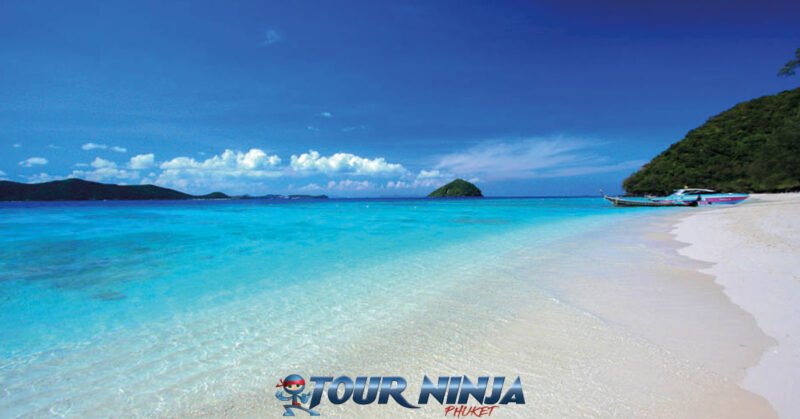 phuket-island-daytrip-snorkel-1 coral island beautiful stretch of white beach and crystal clear sea with blue sky and tropical islands in background