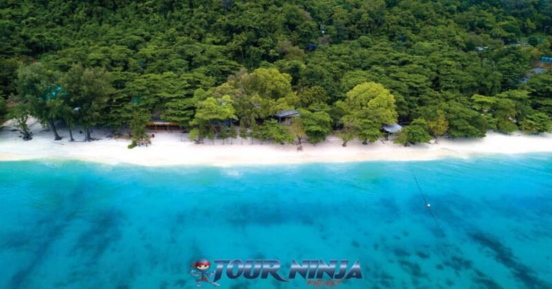 phuket-island-daytrip-snorkel-2 coral island aerial view of crystal clear sea and beautiful stretch of white beach and green trees in background
