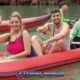 james bond island tour in phangnga bay with a young couple sitting in a red inflatable kayak with a tour guide paddling
