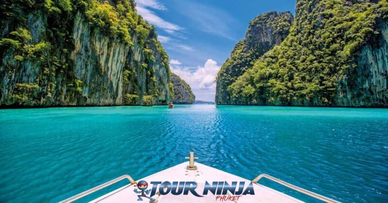 snorkeling-pileh-lagoon-phiphi-island-s11 pileh lagoon phi phi island viewed from a speedboat surrounded by limestone rock formations on a bright sunny day