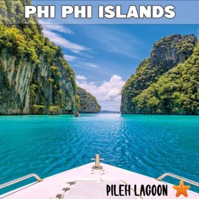 pileh lagoon phi phi island viewed from a speedboat surrounded by limestone rock formations on a bright sunny day