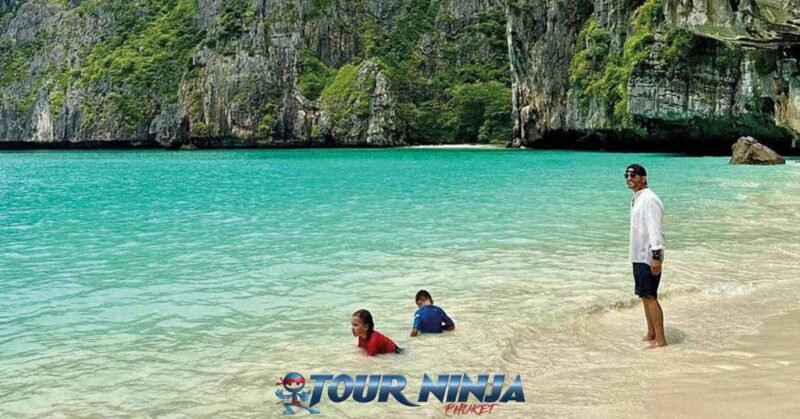 snorkeling-tours-phuket-3 snorkeling tour phuket with a male watching over two kids playing in the shallow water in a small bay