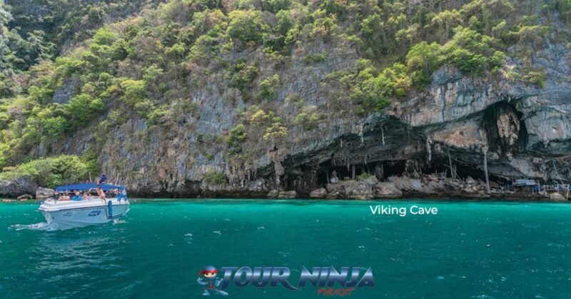 snorkeling-viking-cave-phiphi-island-s1 viking cave on phi phi island with a white speedboat moored up near by sightseeing and snorkeling