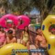andamanda phuket water park with six smiling teenagers carrying large inflatable tubes for use in the water sliders