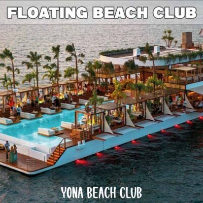 yona beach club aerial view showing entire vessel moored in calm blue sea at sunset