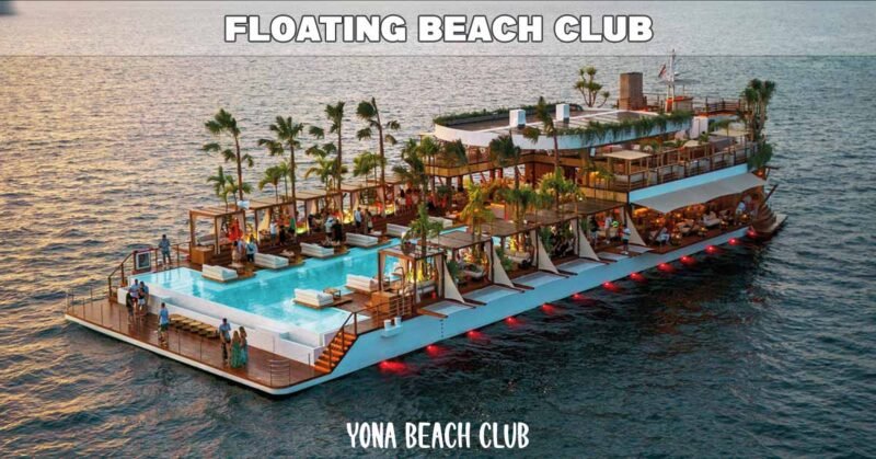 yona beach club aerial view showing entire vessel moored in calm blue sea at sunset