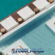 aerial view of yona beach club sea beds at the back of the vessel close to the water and showing the swimming pool